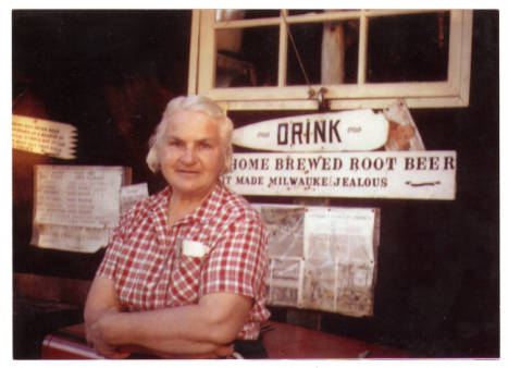 Dorothy Molter standing in front of the Cocacola cooler in which she kept her homemade root beer Isle of Pines Knife Lake Boundary Waters Canoe Area Minnesota